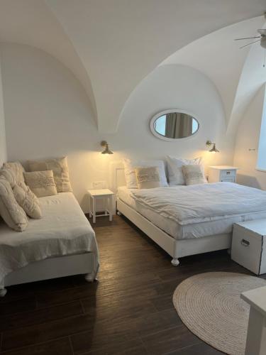 a bedroom with two beds and a mirror at Penzion Kaplanka in Znojmo