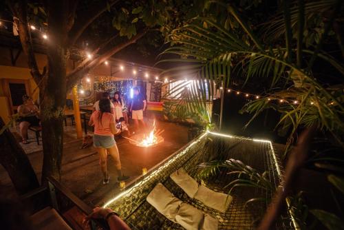 a group of people standing around a table with lights at Costeño River Minca in Minca