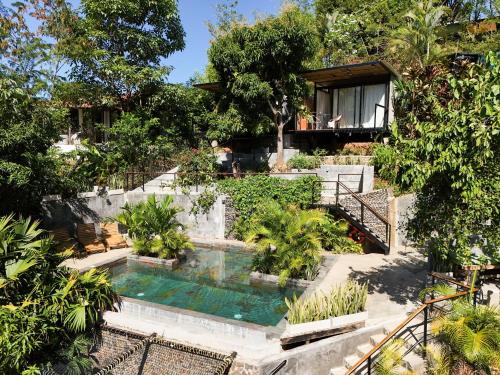 a house with a swimming pool in front of it at Costeño River Minca in Minca