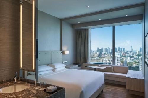 a hotel room with a large bed and a large window at Courtyard by Marriott Singapore Novena in Singapore