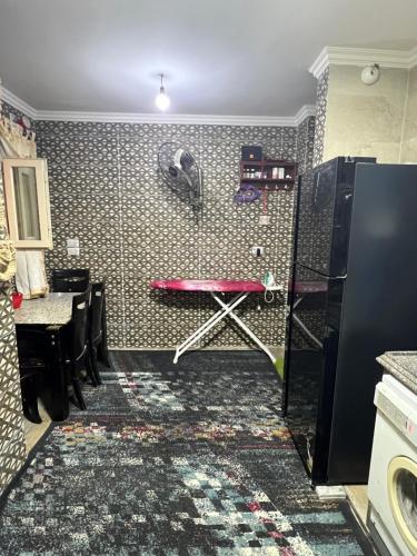 a room with a red stool and a wall at Spacious Master room in newly innovated apt in Dumyāţ al Jadīdah