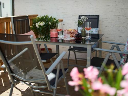 a dining room table with wine glasses and flowers at HAUSmeier in Bad Reichenhall