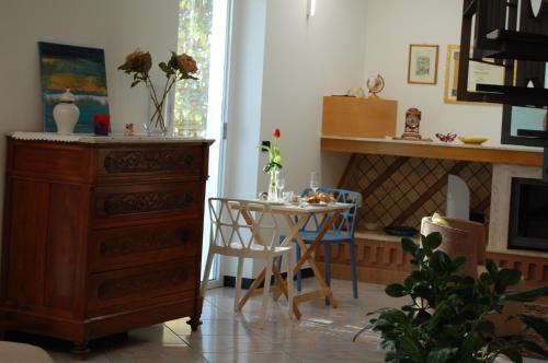 a living room with a table and a dresser and a dining room at Villa Alba in Petacciato