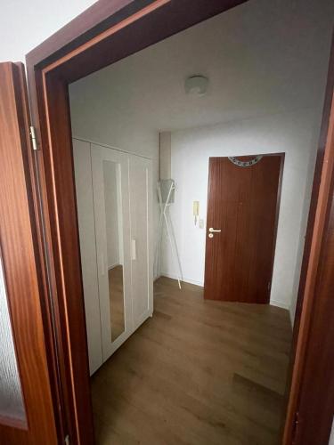 an empty room with a door and a hallway at Wegener Apartments in Mannheim