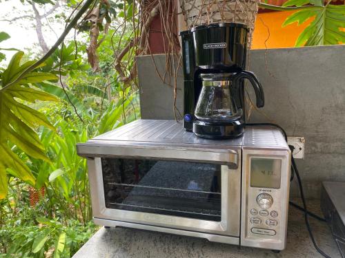 a blender sitting on top of a microwave at A Piece of Paradise in San Carlos