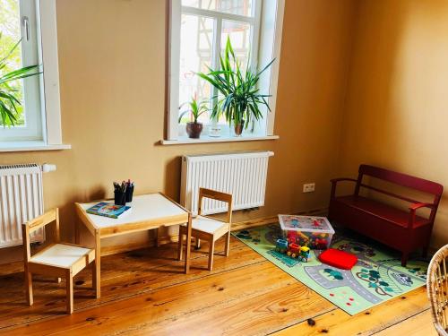 a living room with a table and chairs and a table and a tableablish at Altes Pfarrhaus Neustädt in Neustädt