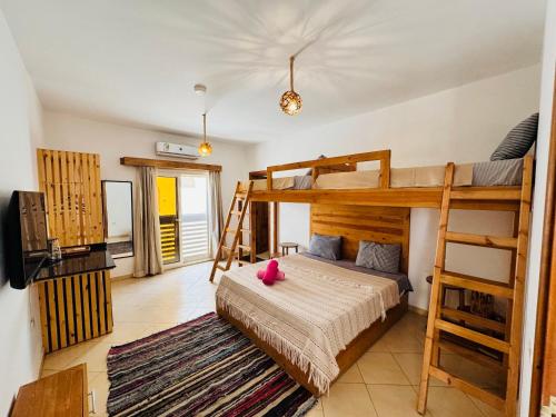 a bedroom with a bunk bed and a tv at Ocean Life Dahab in Dahab