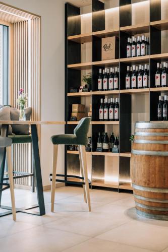 a wine tasting room with a shelf of wine bottles at Weingut Radl in Klöch
