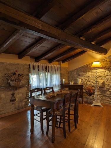 a dining room with a wooden table and chairs at Mulino del Lentino in Nibbiano