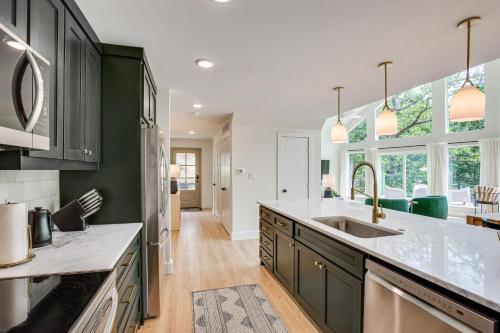 a kitchen with black cabinets and white counter tops at Dock and Fire Pit Lakefront Home in Malakoff! in Malakoff