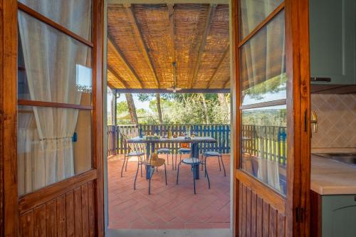 an open door to a patio with a table and chairs at Villa Sunshine apartments in Gambassi Terme