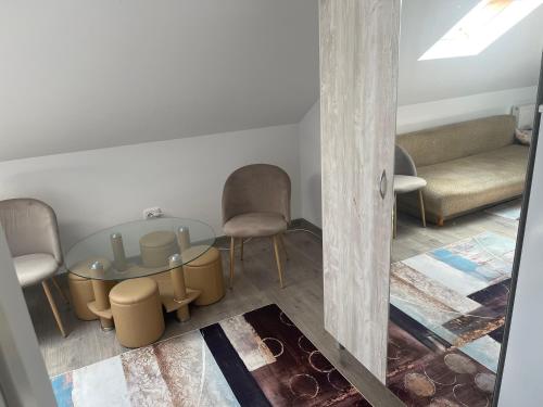 a room with a table and chairs and a couch at Casa din dâmb in Cluj-Napoca