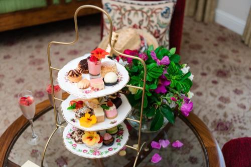 a three tiered display of desserts on a table at Fernhill House Hotel & Gardens in Clonakilty