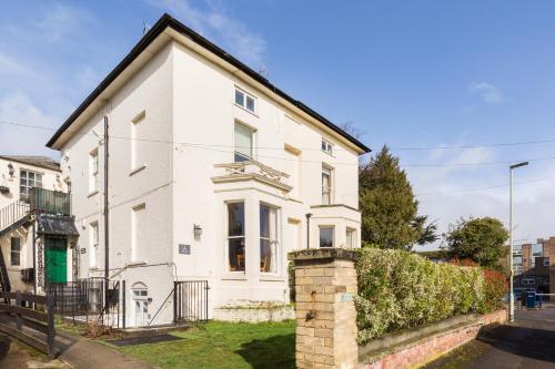 a white house with a black roof at 2 Spa Villas Gloucester in Gloucester