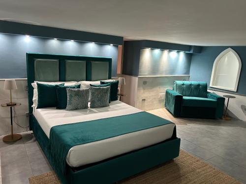 a bedroom with a large bed and a couch at A un passo dal Castello Maschio ANGIOINO Appartment in Naples