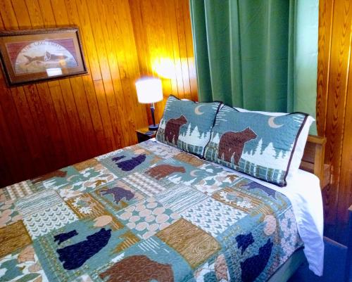 a bedroom with a bed with a quilt on it at The Evening Shade River Lodge and Cabins in Chimney Rock