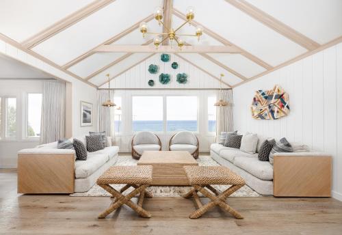 a living room with two couches and a table at Gurney's Montauk Resort & Seawater Spa in Montauk
