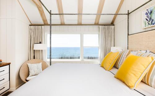 a bedroom with a large bed with a large window at Gurney's Montauk Resort & Seawater Spa in Montauk