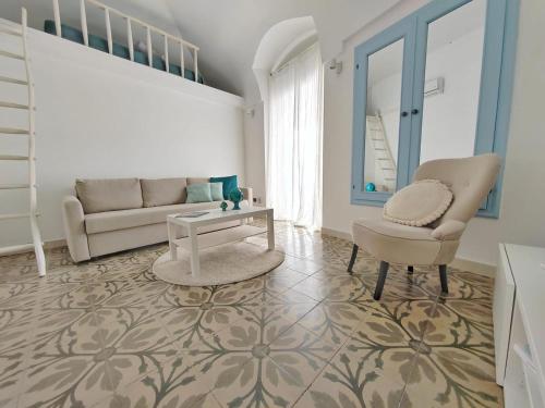 a living room with a couch and a chair at Dimora Barbacana in Monopoli