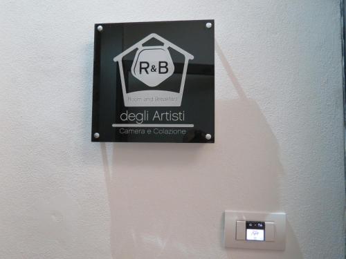 a sign on a wall that says devil atheist at Artisti Rooms in Ravenna