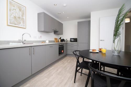 a kitchen with a table and a dining room at Boutique One BR | Free Parking in Taunton