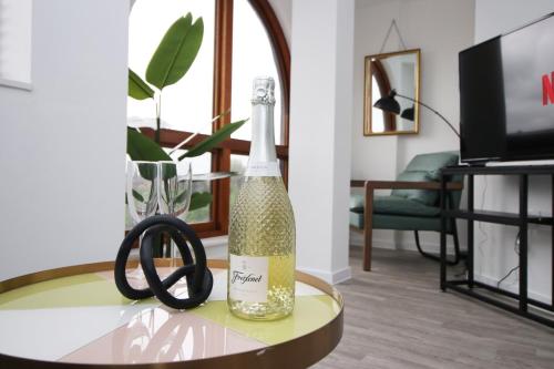 a bottle of champagne on a table in a living room at Boutique One BR | Free Parking in Taunton