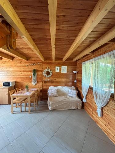 a room with a bed and a table in a room at Kopalino 7th Heaven in Kopalino