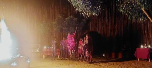 a group of people sitting in chairs on a stage at MONKEY MOUNTAIN LODGE in Mtende
