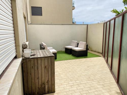 a patio with two chairs and a table on a balcony at 2 bedrooms apartement at Espinho 600 m away from the beach with furnished terrace in Espinho