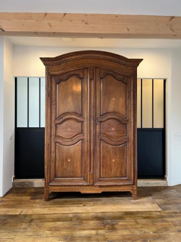 a large wooden cabinet in a room with wooden floors at Château d'Aynac in Aynac