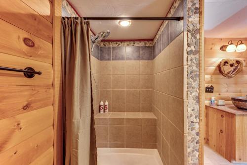 a bathroom with a shower with a shower curtain at Tranquil Thornton Cabin Deck, Views and Game Room! in Thornton