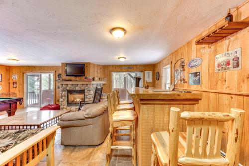 a kitchen and living room with a couch and a table at Tranquil Thornton Cabin Deck, Views and Game Room! in Thornton