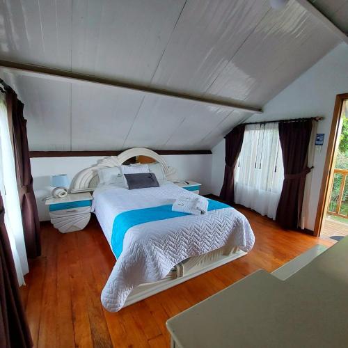 a bedroom with a large bed in a room at Hosteria Airport Garden in Tababela