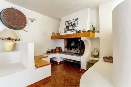 a living room with a fireplace in a house at 2 bedrooms apartement with enclosed garden and wifi at Tollo 6 km away from the beach in Tollo