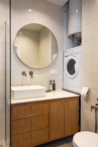 une salle de bain avec un lavabo et une machine à laver dans l'établissement Heart of le Marais, à Paris