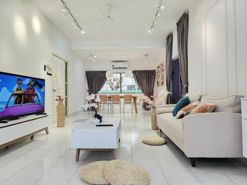 a living room with a couch and a flat screen tv at Petaling Jaya SS14 Bungalow for 20Pax, Plaza33 , 3 2 Square, Jaya One , SS2 in Petaling Jaya