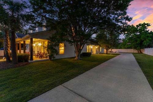 a driveway leading to a house at dusk at A World Away by Newman-Dailey in Destin