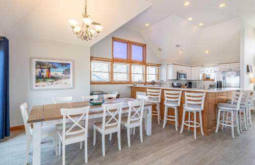 a kitchen and dining room with a table and chairs at On Island Time in Kill Devil Hills