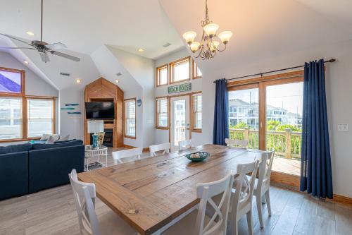 a dining room and living room with a wooden table and chairs at On Island Time in Kill Devil Hills