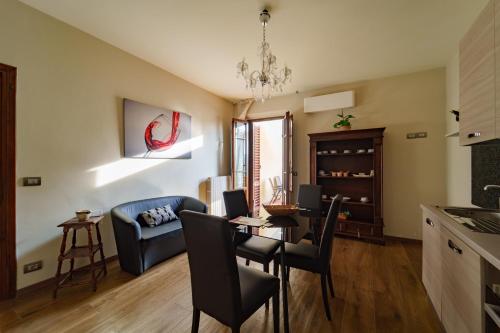 a kitchen and living room with a table and chairs at Villa Desideria in Figline Valdarno