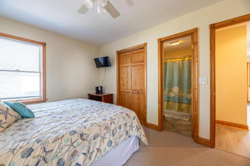 a bedroom with a bed and a window at On Island Time in Kill Devil Hills