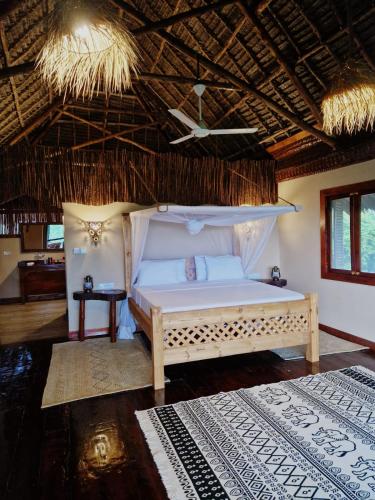 a bedroom with a bed in a room at MONKEY MOUNTAIN LODGE in Mtende