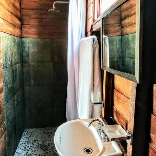 a bathroom with a sink and a shower at Ecoco Holbox - EcoChic - Cabañas de Madera - Holbox Retreat in Holbox Island