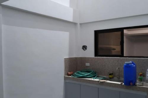 a kitchen counter with a sink and a mirror at Peaceful Fully Furnished Spacious Home Imus Cavite in Imus