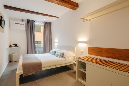 a small bedroom with a bed and a window at OBLO' Guesthouse in Portovenere