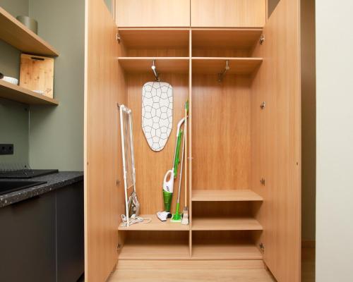 a cupboard with golf equipment in a kitchen at Design apartments between National Art Museum and Arena Riga in Rīga