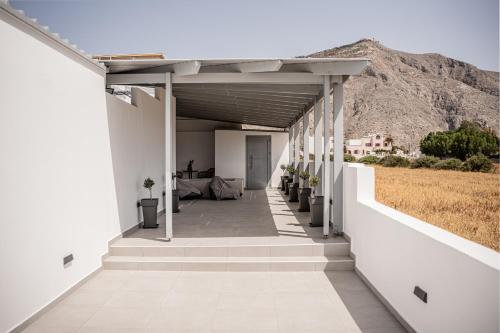 a hallway of a building with a mountain in the background at White Note Luxury Suites in Perivolos