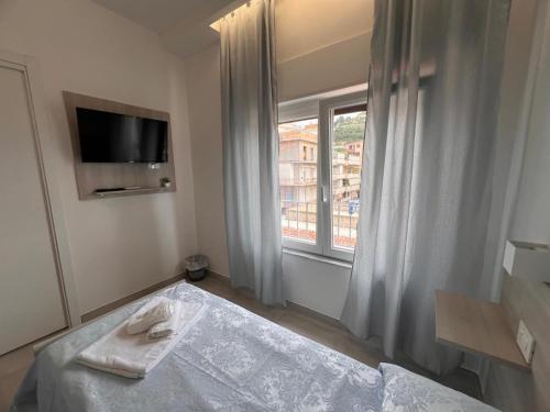 a hotel room with a bed and a window at Porta sul Mare in Tropea
