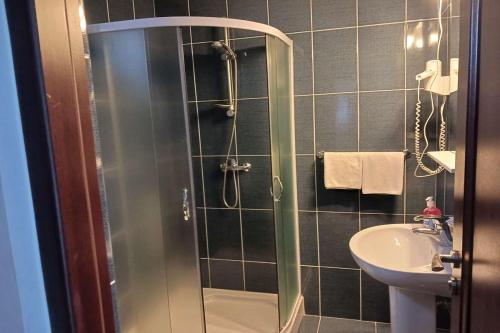 a bathroom with a shower and a sink at Pensiunea Cionca str 1 Decembrie 1918 nr 466 in Gilău