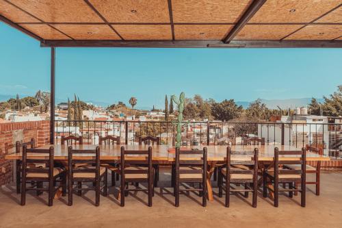 a large wooden table and chairs on a patio at Hotel Casa Acueducto - Lujo Cultural in Oaxaca City